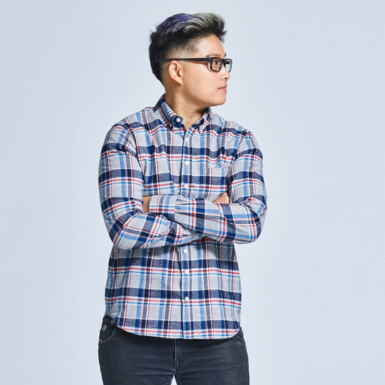 Androgynous model posing with turned head and arms folded wearing Kirrin Finch Bly brushed flannel