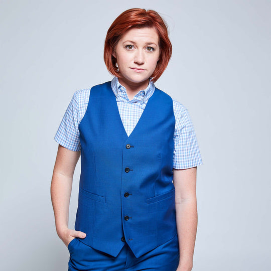 Androgynous model wearing nautical blue vest with black buttons