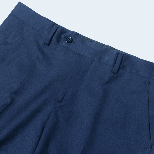 Close up of Georgie Navy Dress pants at 3/4 angle on neutral background