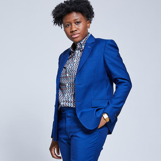 Androgynous model Doreen wearing the Royal Blue Suit Blazer and Dress Pants. She is stoically posing with her hand in the dress pants pocket.