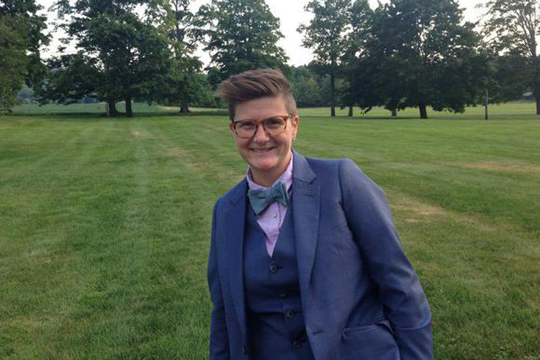 Laura posing in a suit with a bowtie 