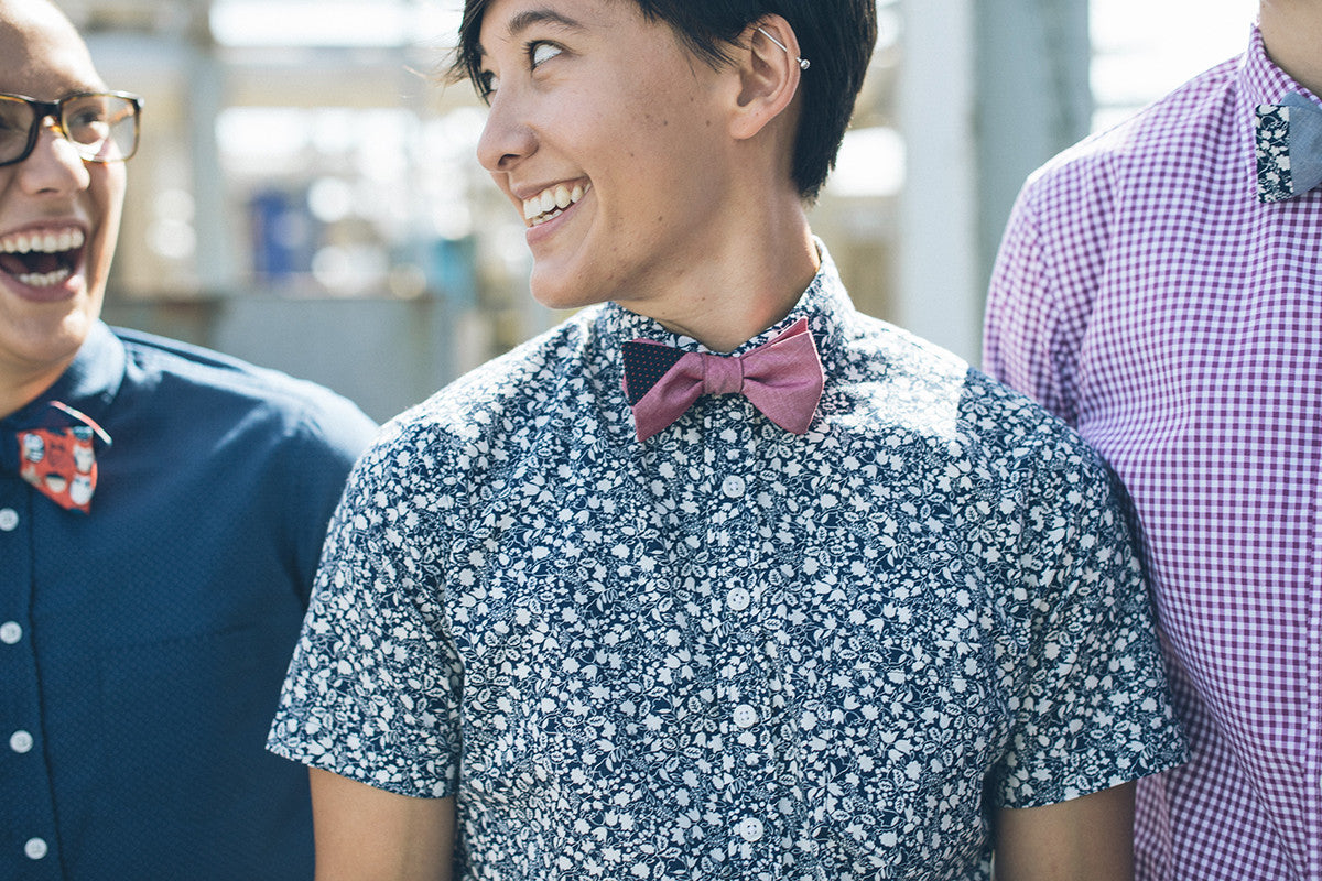 Red bowtie on a blue and white shirt.