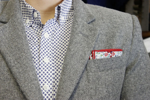 Gray suit with red and blue pocket square.
