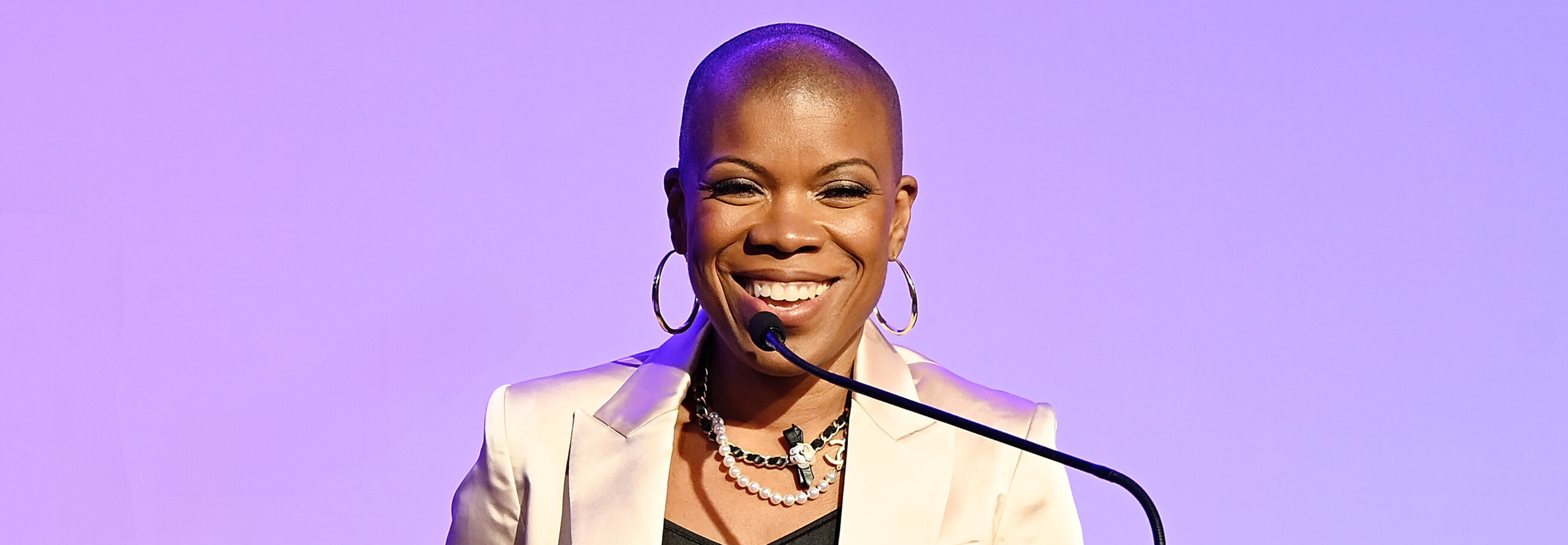 Dapper Scout Jaymes Black speaking at a podium