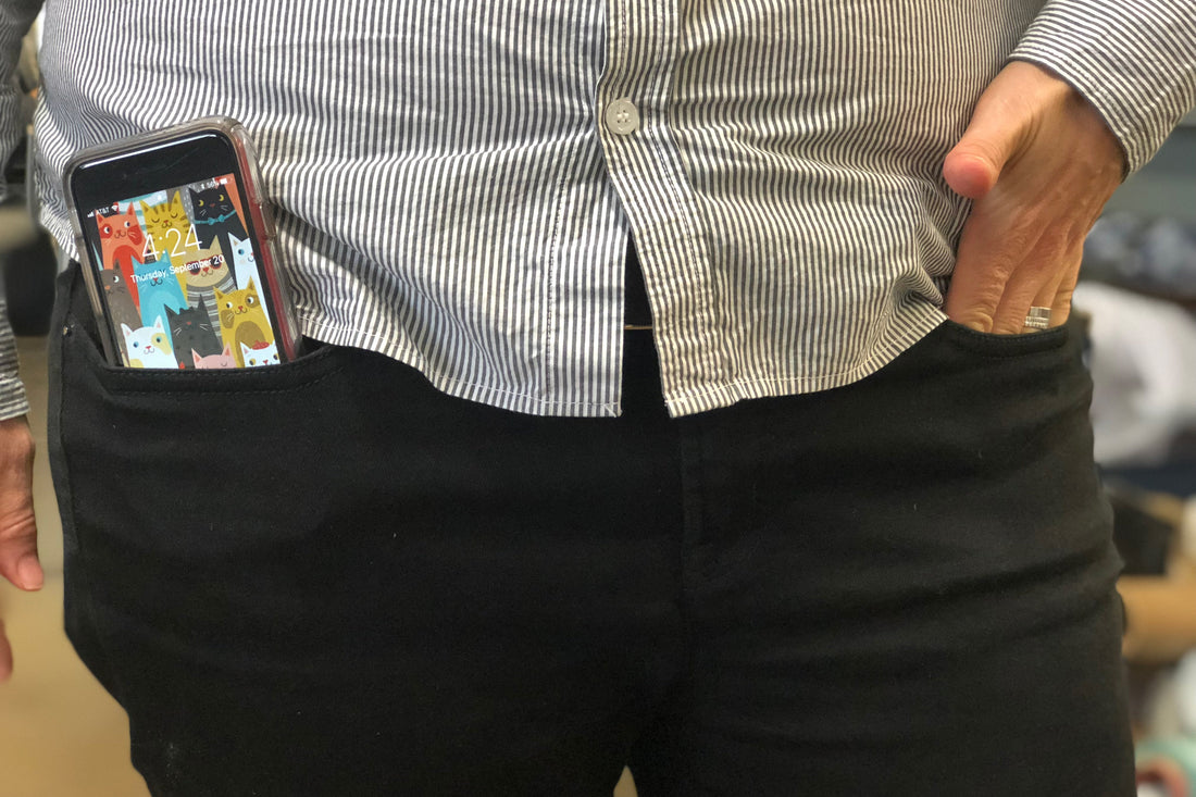 Person with phone sticking out of their pants pocket