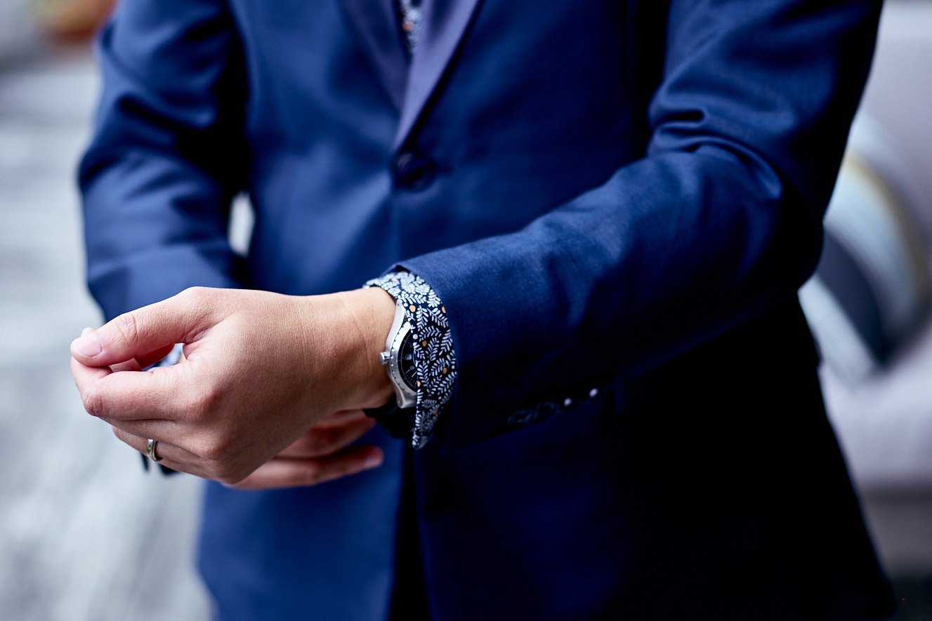 Image of someone wearing a suit and watch.