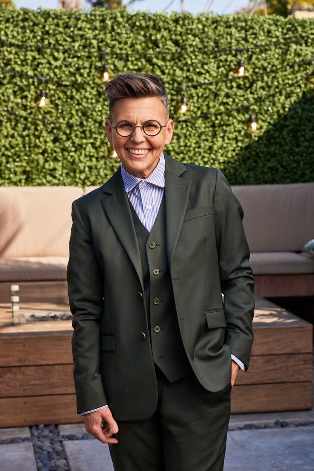 Androgynous model wearing olive suit