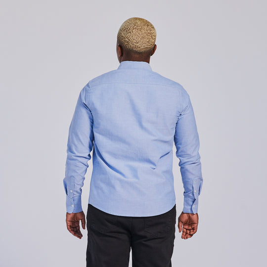 Blue Oxford shirt worn by masc presenting  model