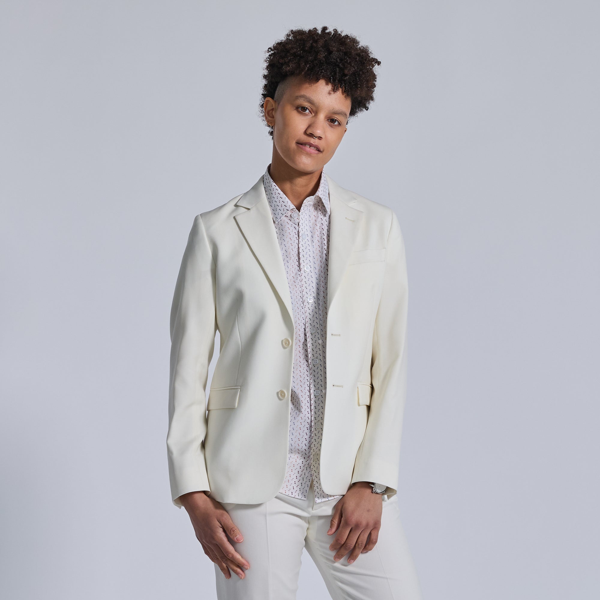 Non-binary model in Ivory Wedding Suit by Kirrin Finch. Color: Ivory