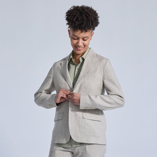 non-binary model in sand linen suit with sage linen shirt