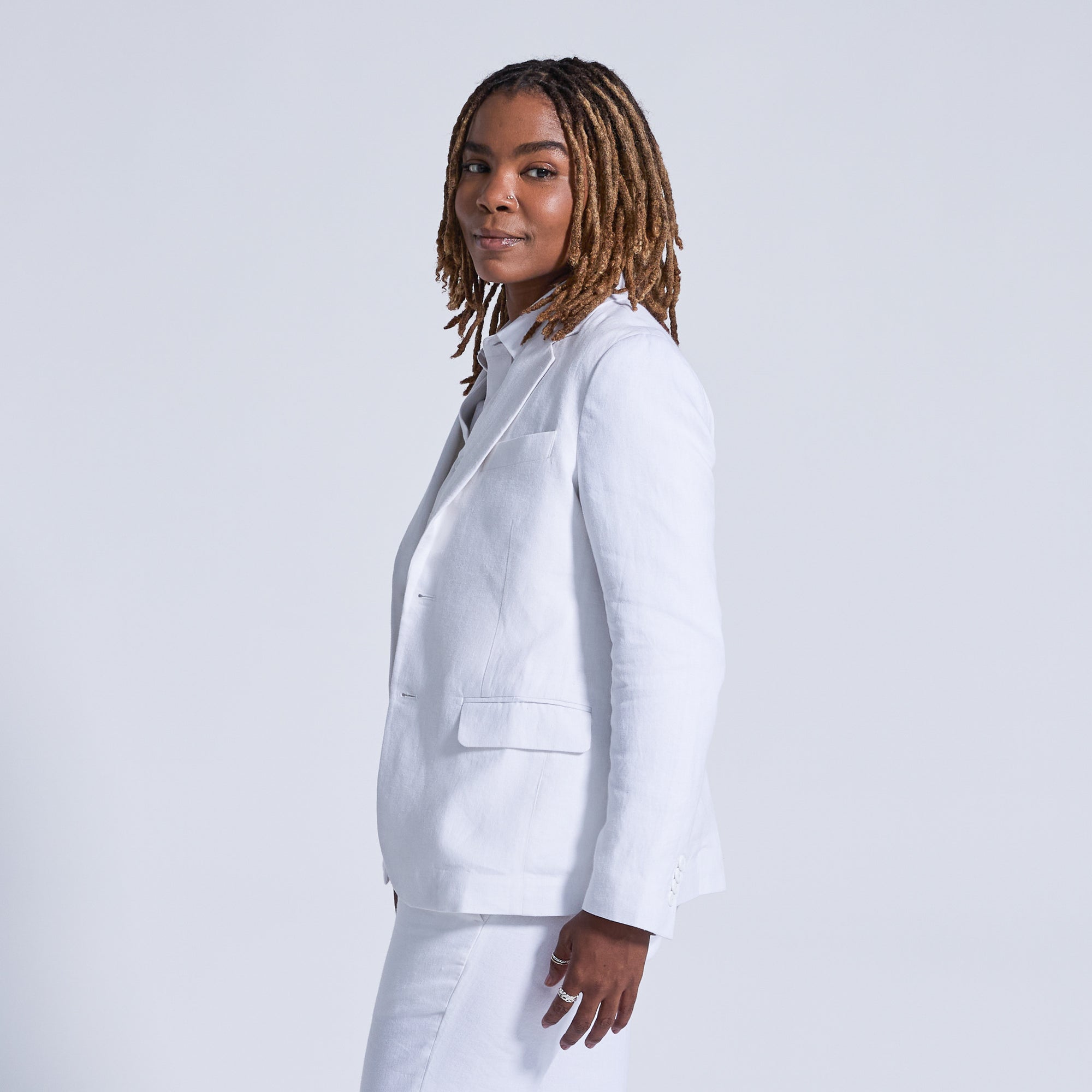 Model posing in White Sand linen blazer made by Kirrin Finch.