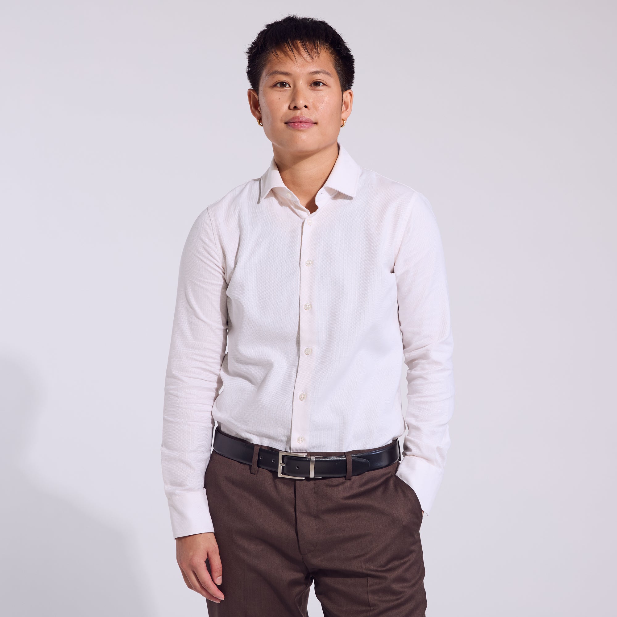 Androgynous model wearing the Ivory Basketweave Frankie dress shirt made for women, trans, masc and non-binary folks.  Color: Ivory Basketweave