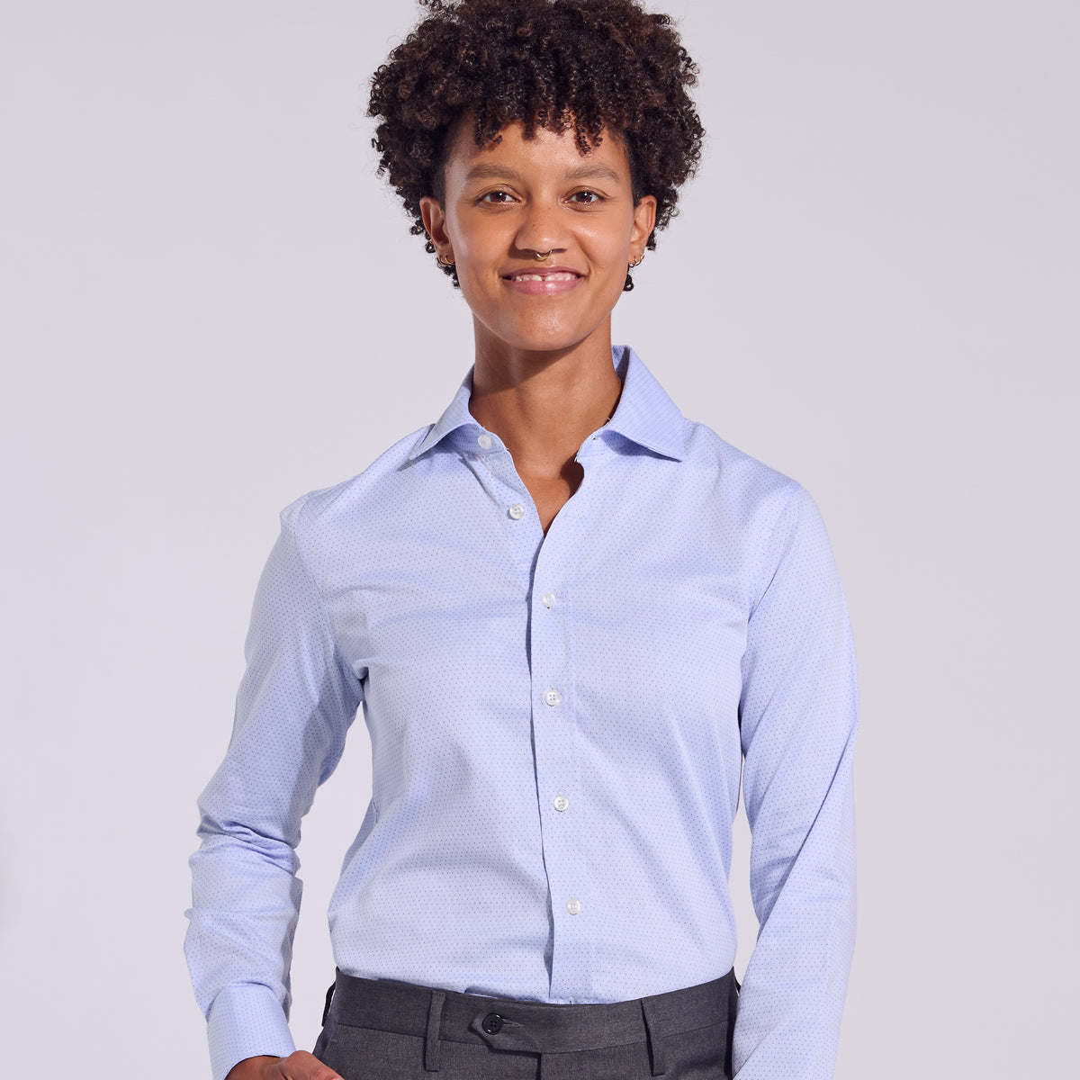 Androgynous person in the business casual swiss dot dress shirt