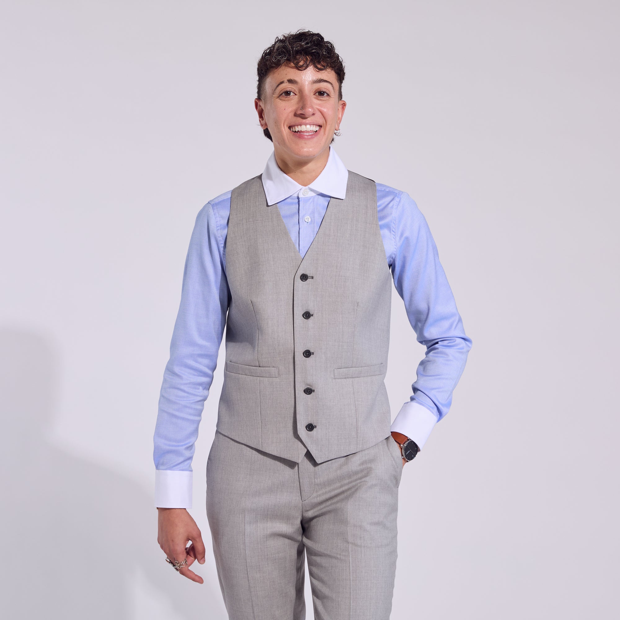 Androgynous Model wearing sky blue banker shirt paired with light gray vest. Color: Sky Blue Banker