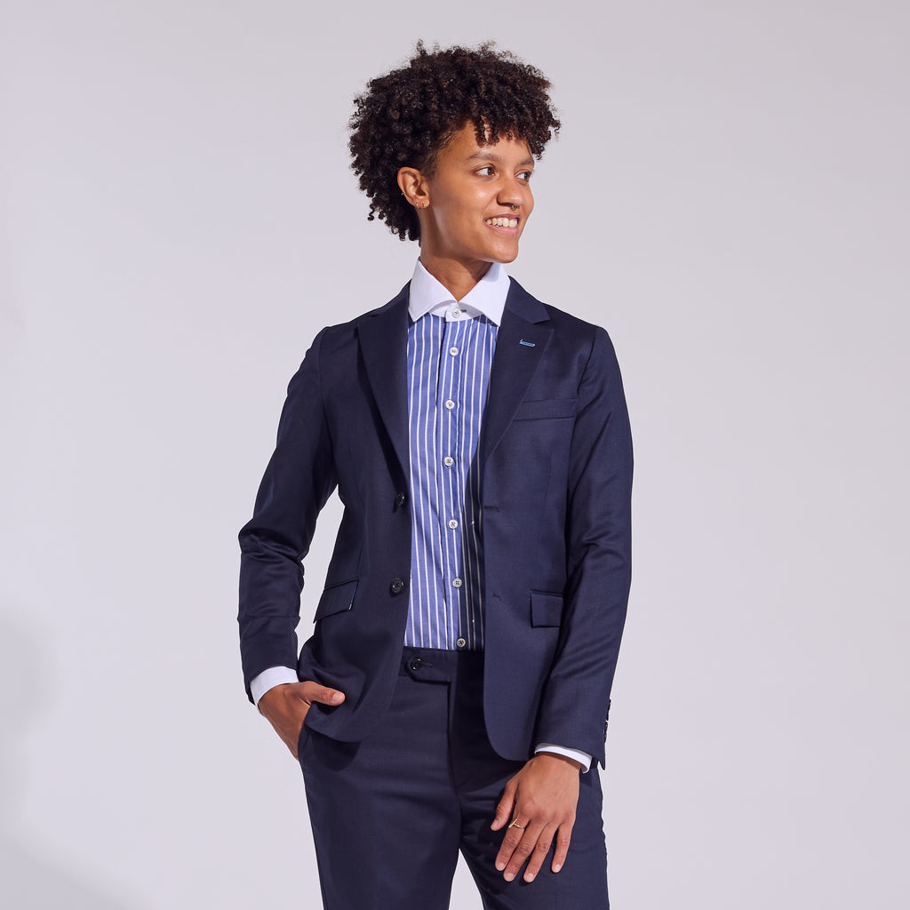 Model wearing dark blue banker shirt paired with blazer by Kirrn Finch.  Color: Blue Stripe Banker