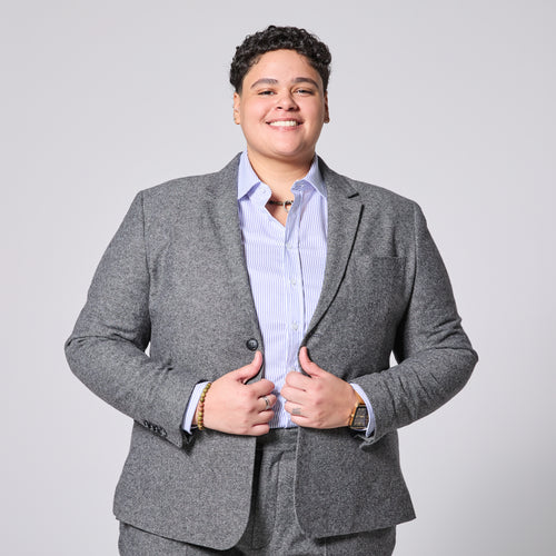 Person wearing Smokey Gray blazer over a light blue shirt on a plain background