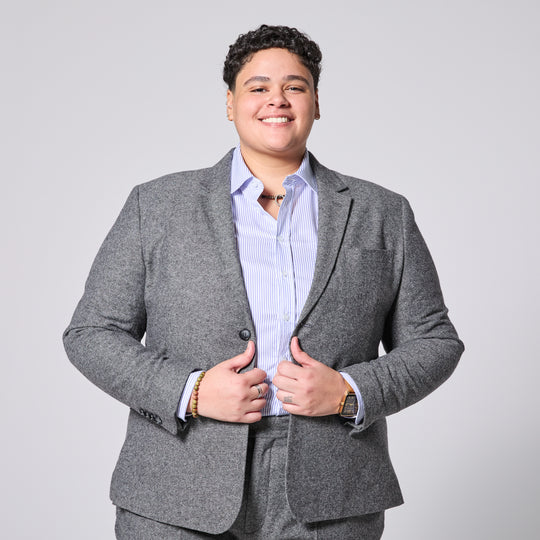 Person wearing Smokey Gray blazer over a light blue shirt on a plain background