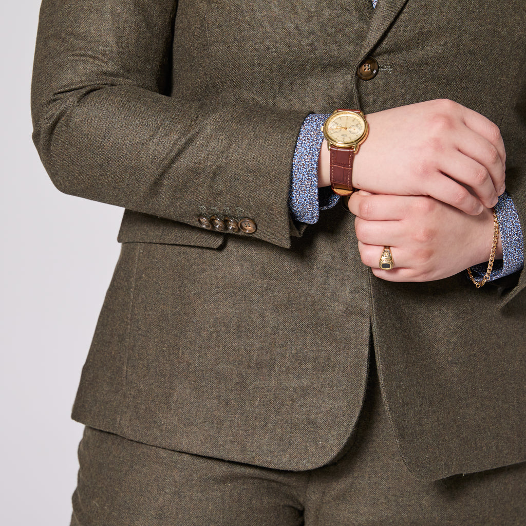 The Finch Heather Olive Flannel Suit Blazer featuring eco-friendly faux horn buttons.