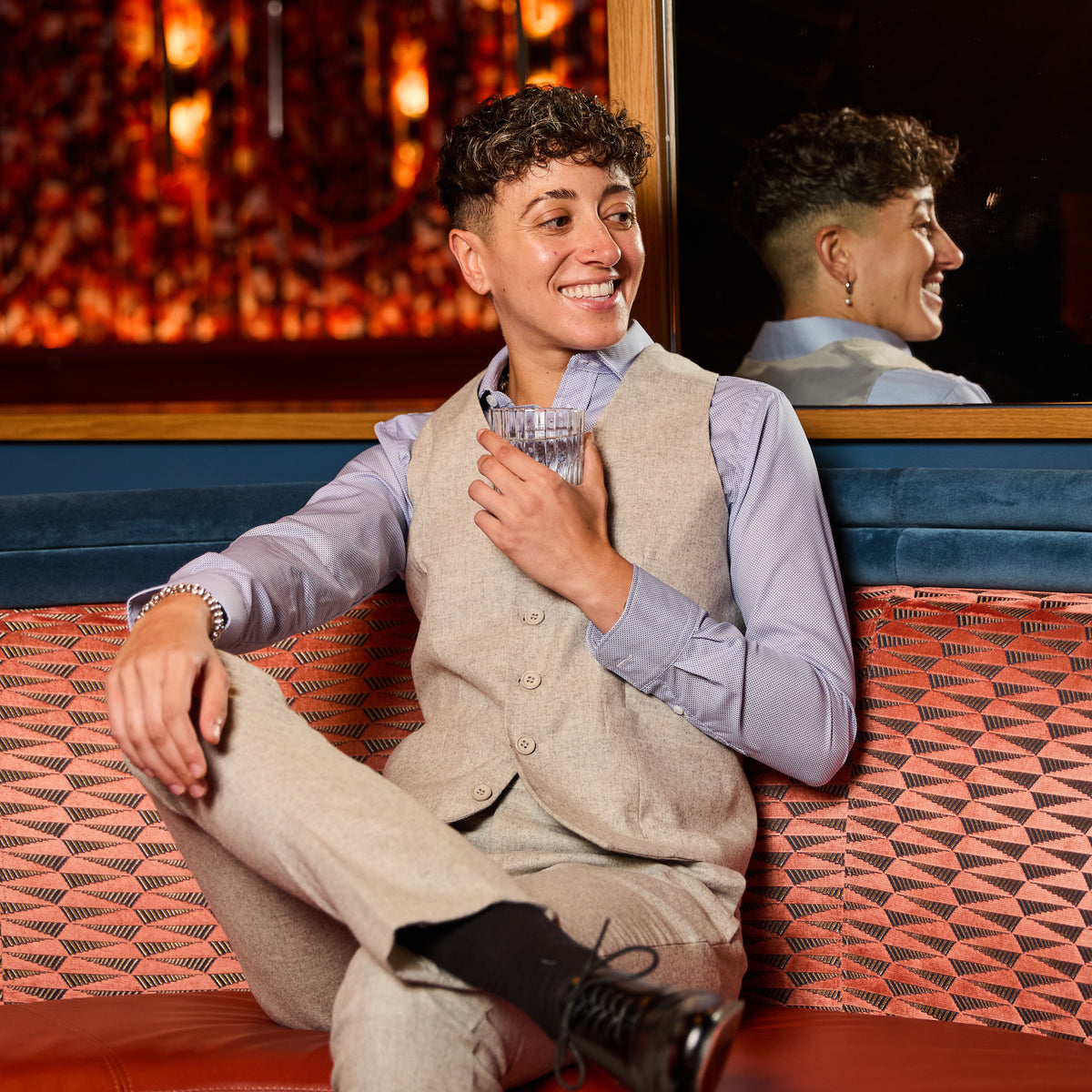 Person sitting in bar booth wearing Heather Gray Flannel Vest made by Kirrin Finch