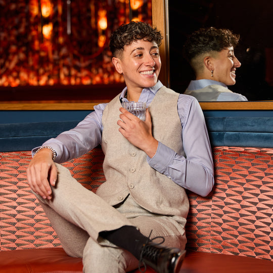 Person sitting in bar booth wearing Heather Gray Flannel Vest made by Kirrin Finch