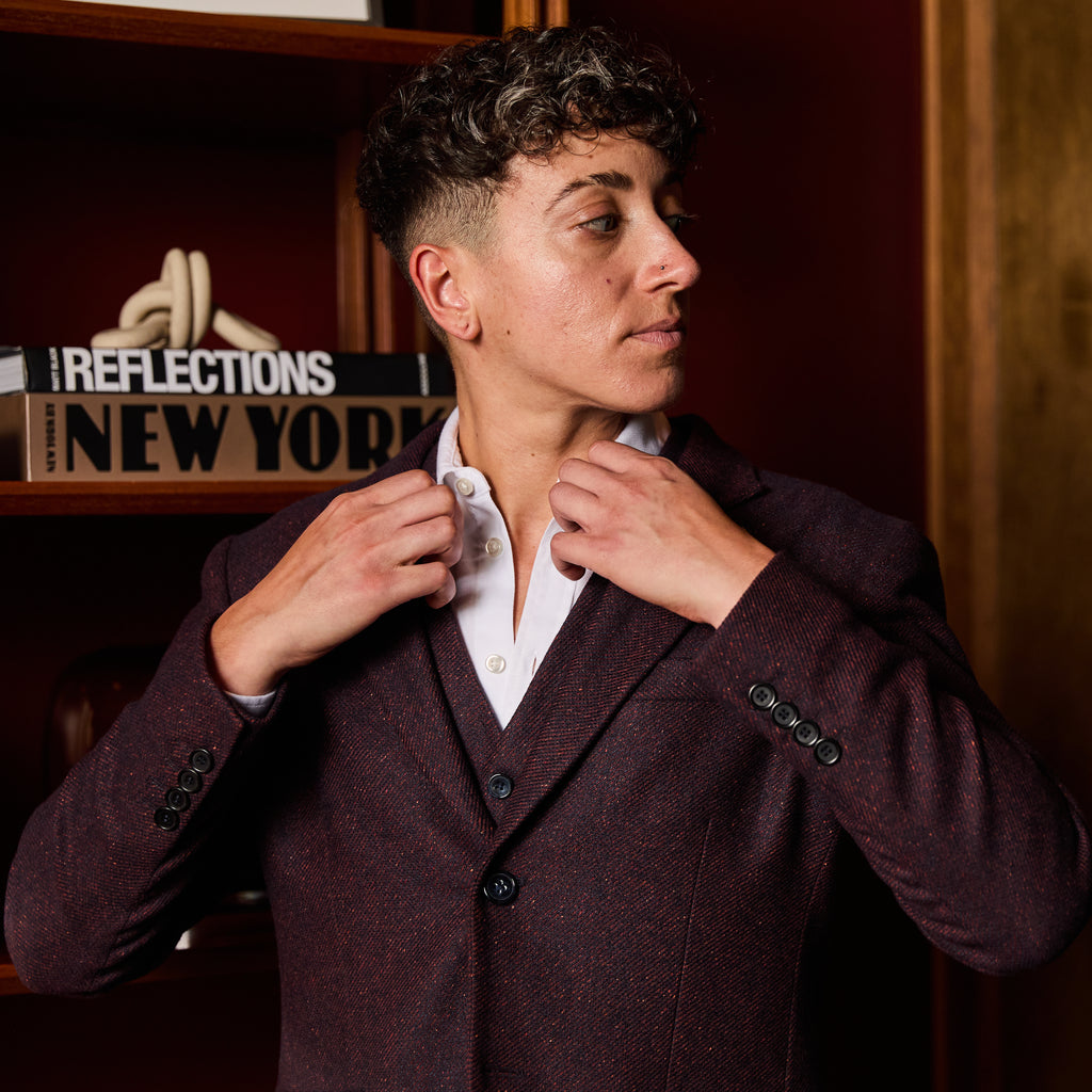 Androgynous Model Adjusting lapel on The Finch Mulberry Twill Blazer