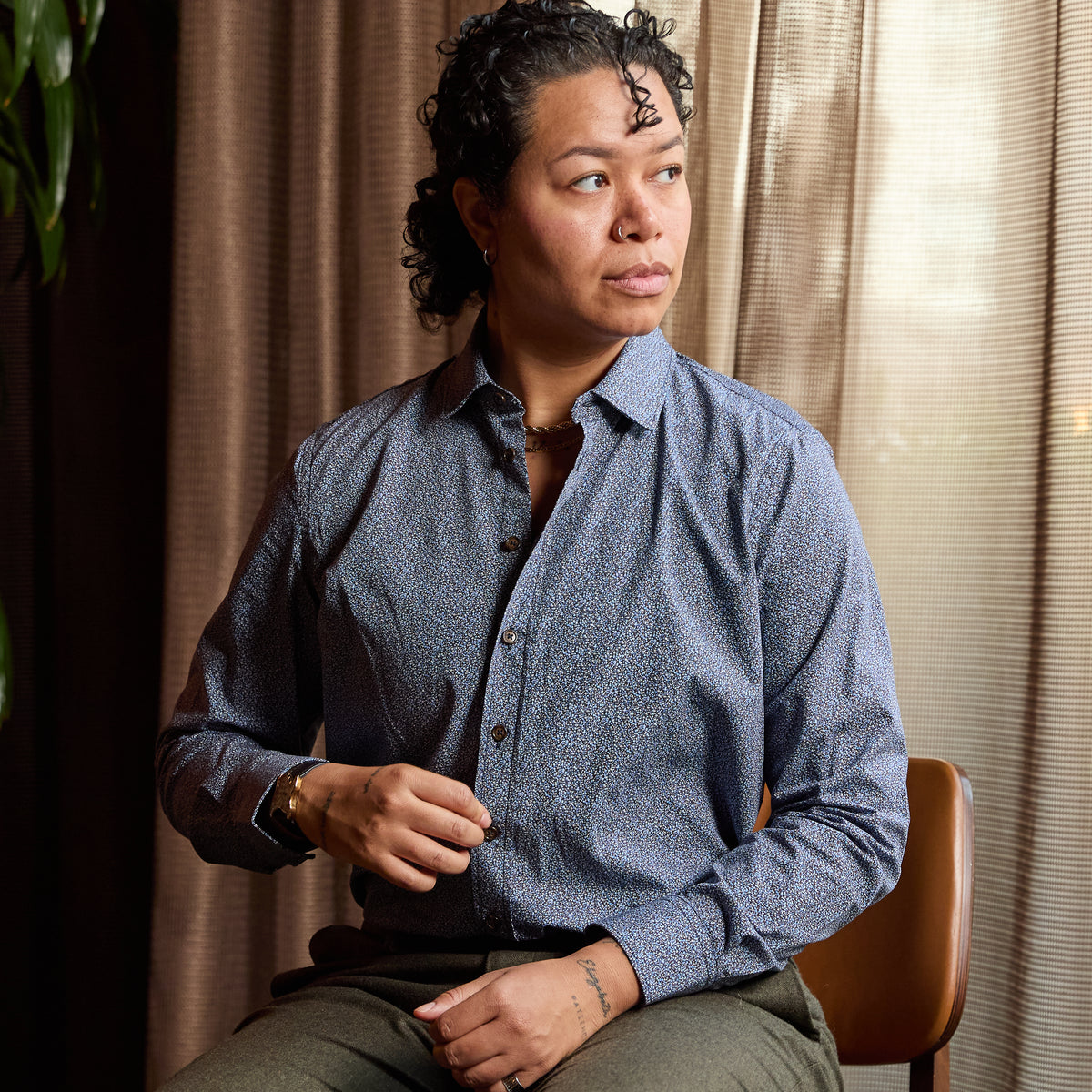 Model wearing Frankie Murano Classic Dress Shirt sitting in a chair.