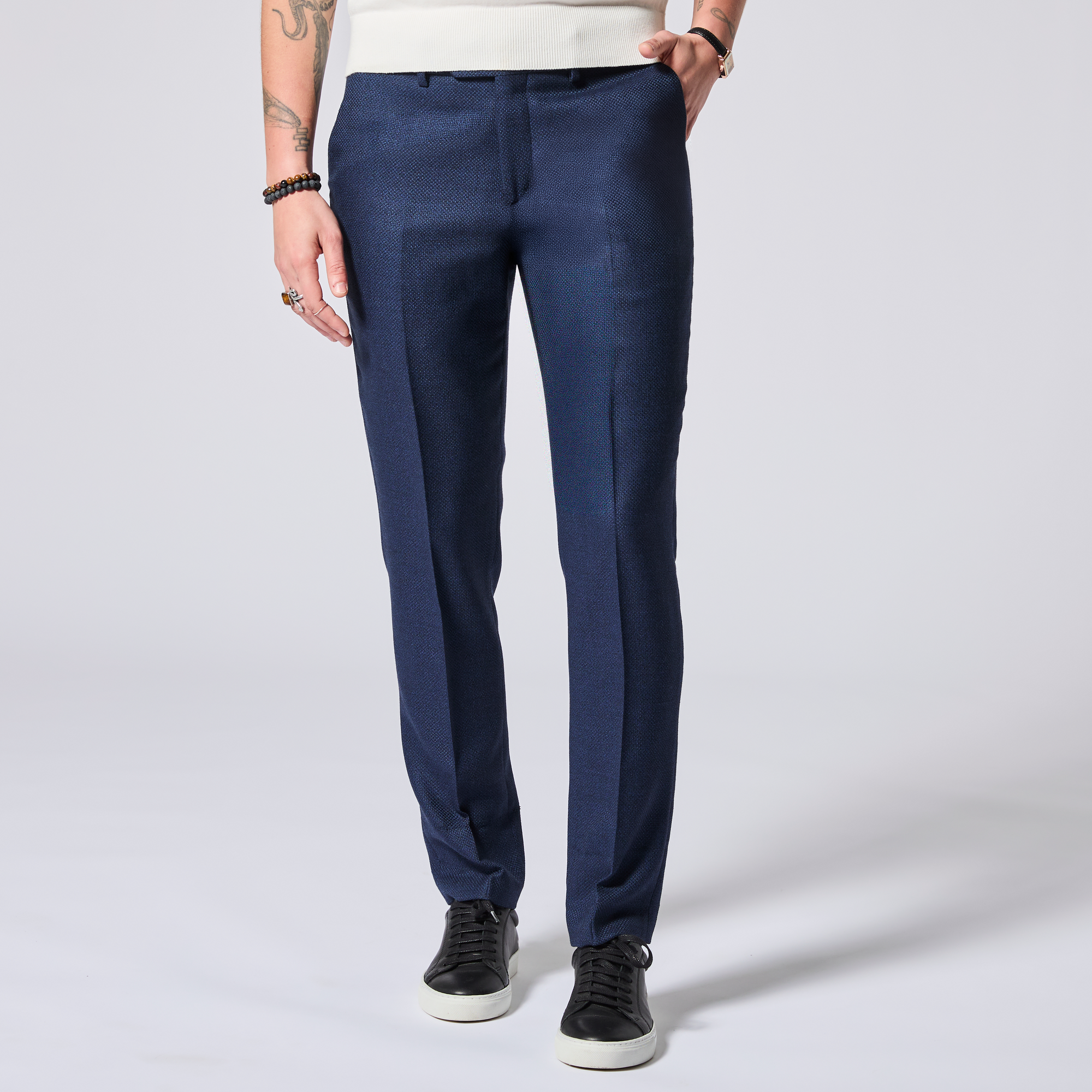 Model wearing navy blue textured pants on a white background. Color: Navy Textured