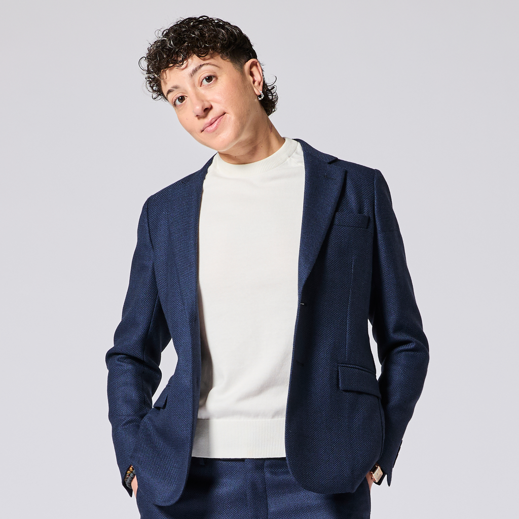 Model wearing a textured navy blazer over a white shirt on a light gray background.  Made for women, trans, masc and non-binary folk. Color: Navy Textured