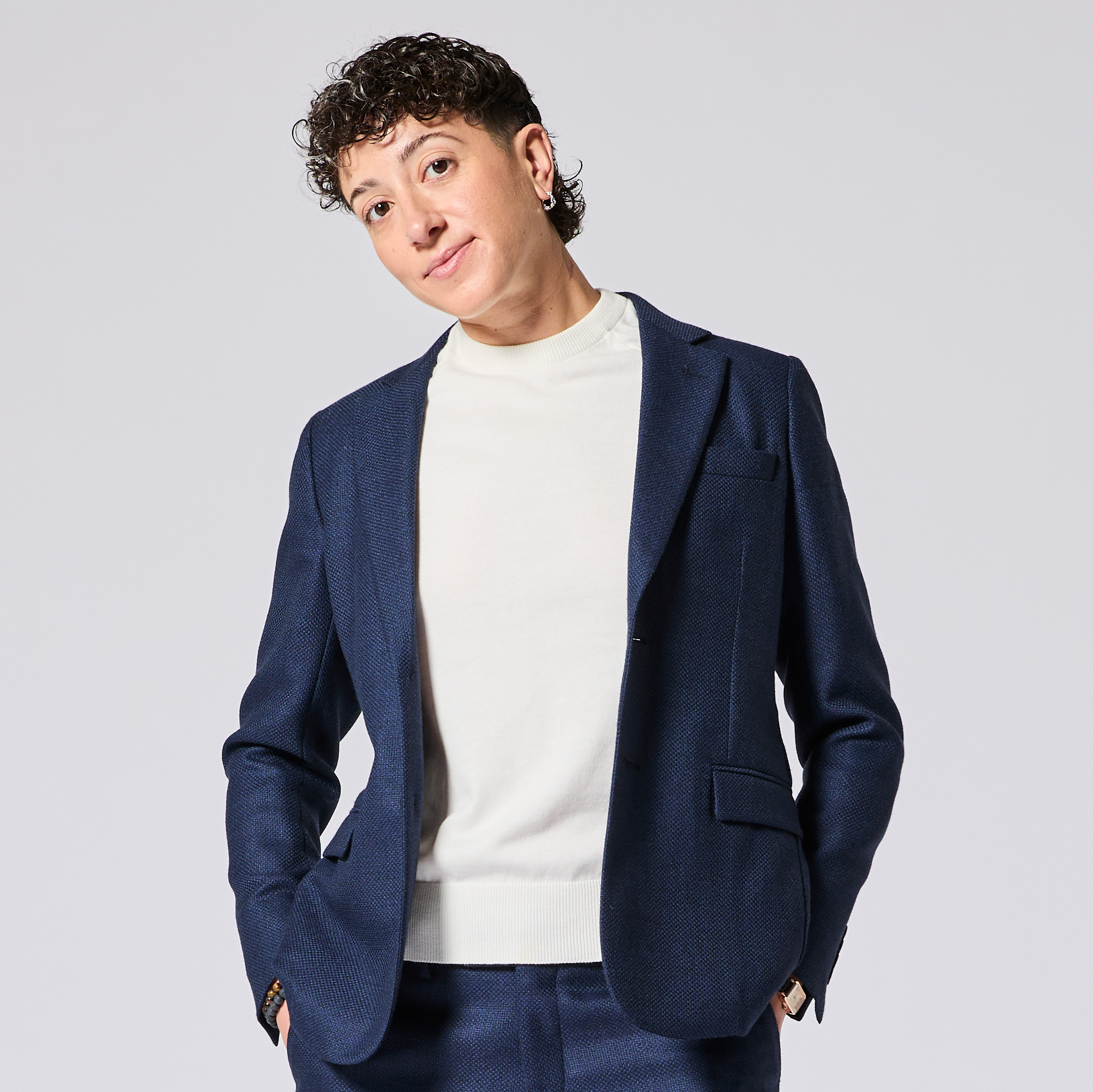 Model wearing a textured navy blazer over a white shirt on a light gray background.  Made for women, trans, masc and non-binary folk. Color: Navy Textured
