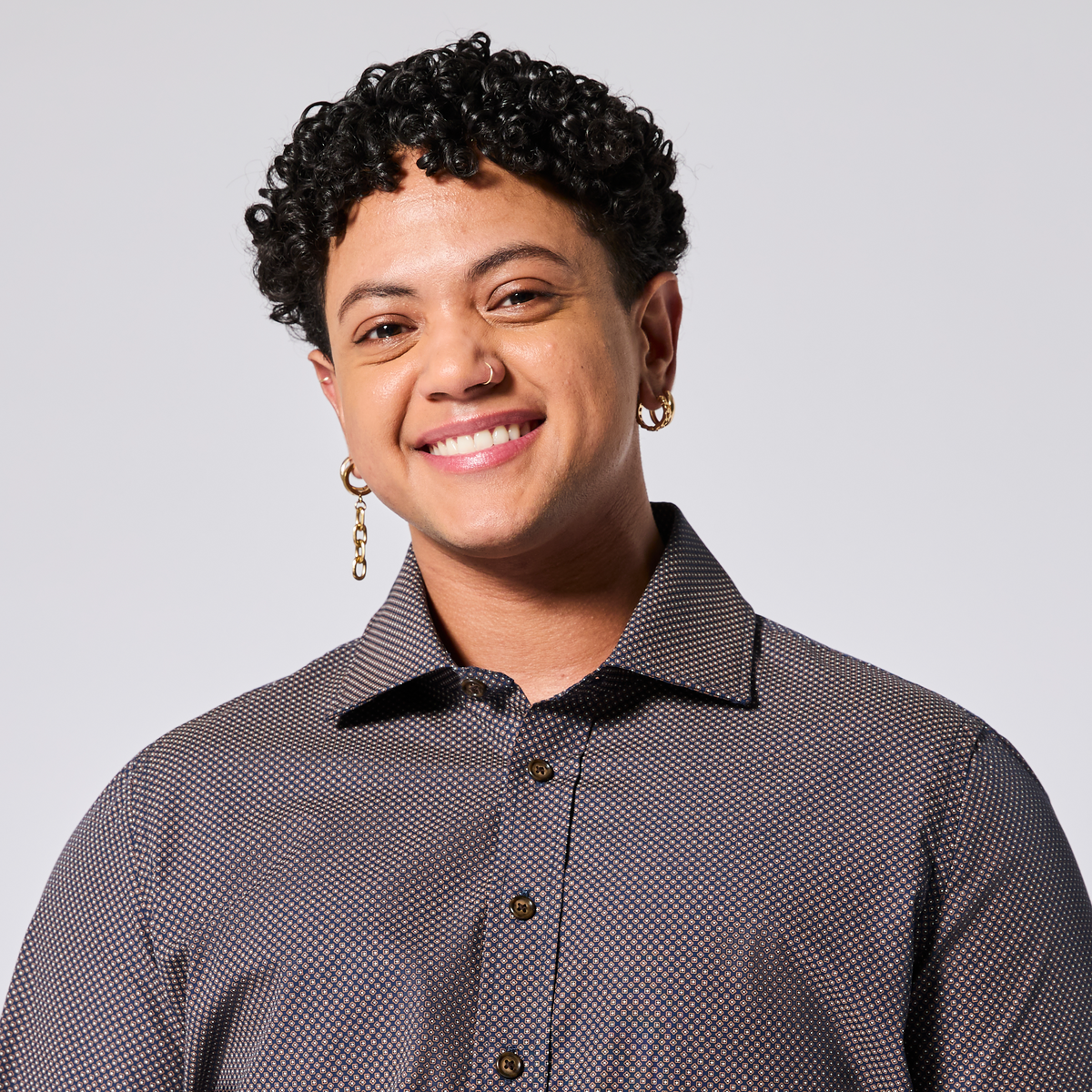 Model wearing a patterned shirt against a plain background. Color: Moroccan Tile