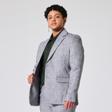 Person wearing a gray suit on a light gray background. Color: Graphite