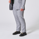 Person wearing a gray suit with with matching pants on a white background. Color: Graphite