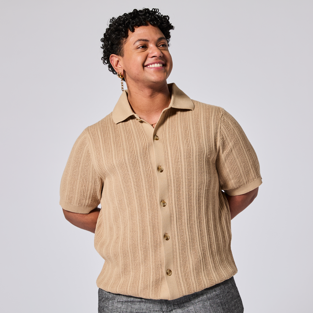 Model wearing a beige short-sleeve cardigan on a light gray background. Color: Camel