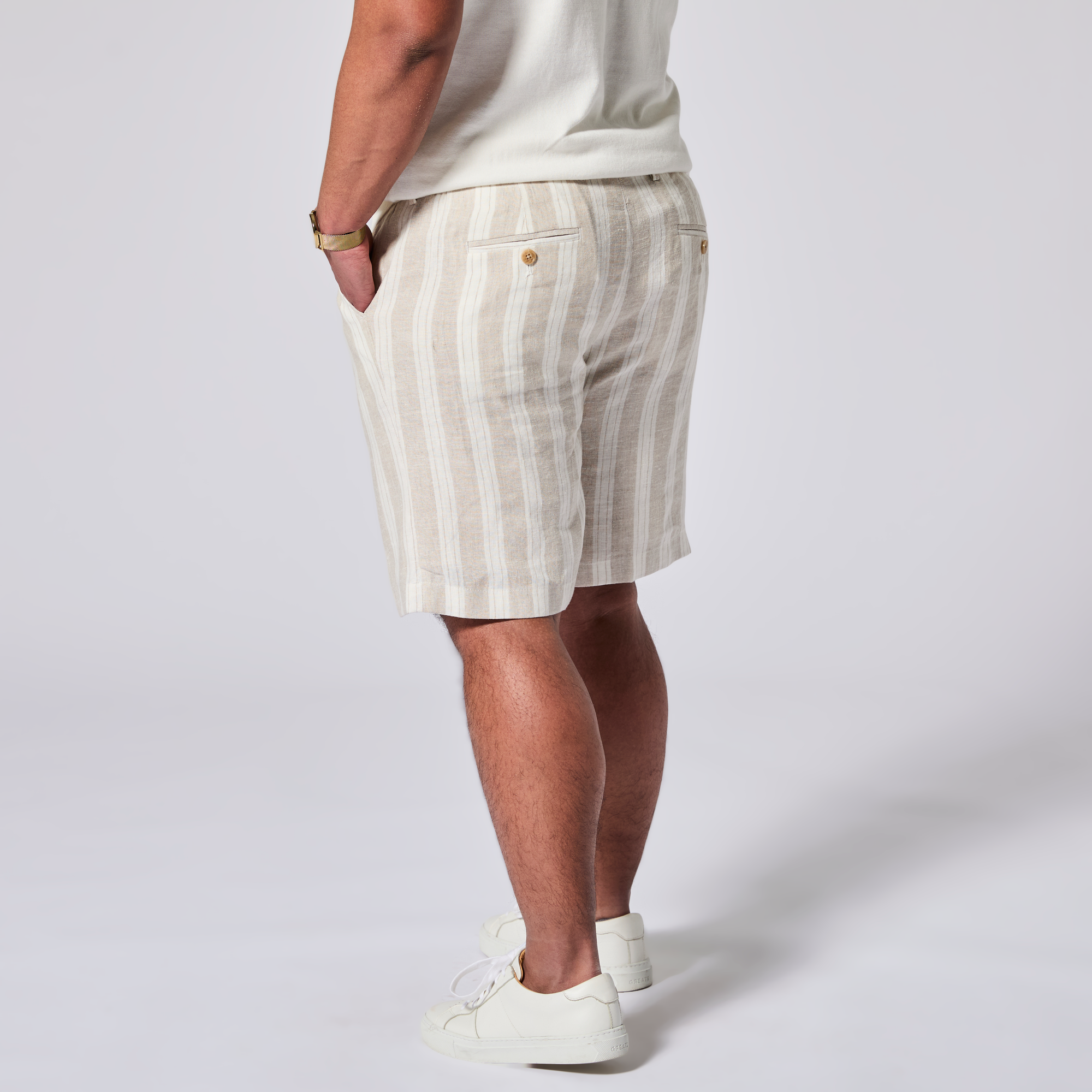 Person wearing striped shorts and a white shirt on a plain background. Color: Sand Wide Stripe