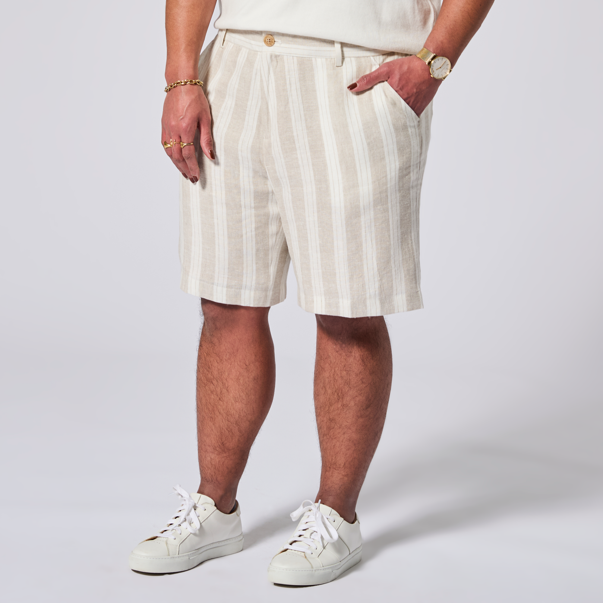 Person wearing white and beige striped shorts with a plain background. Color: Sand Wide Stripe