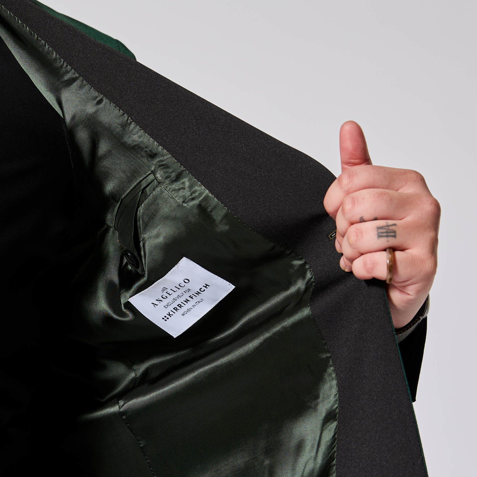 Inside details of the emerald tuxedo blazer made by Kirrin Finch. Color: Emerald