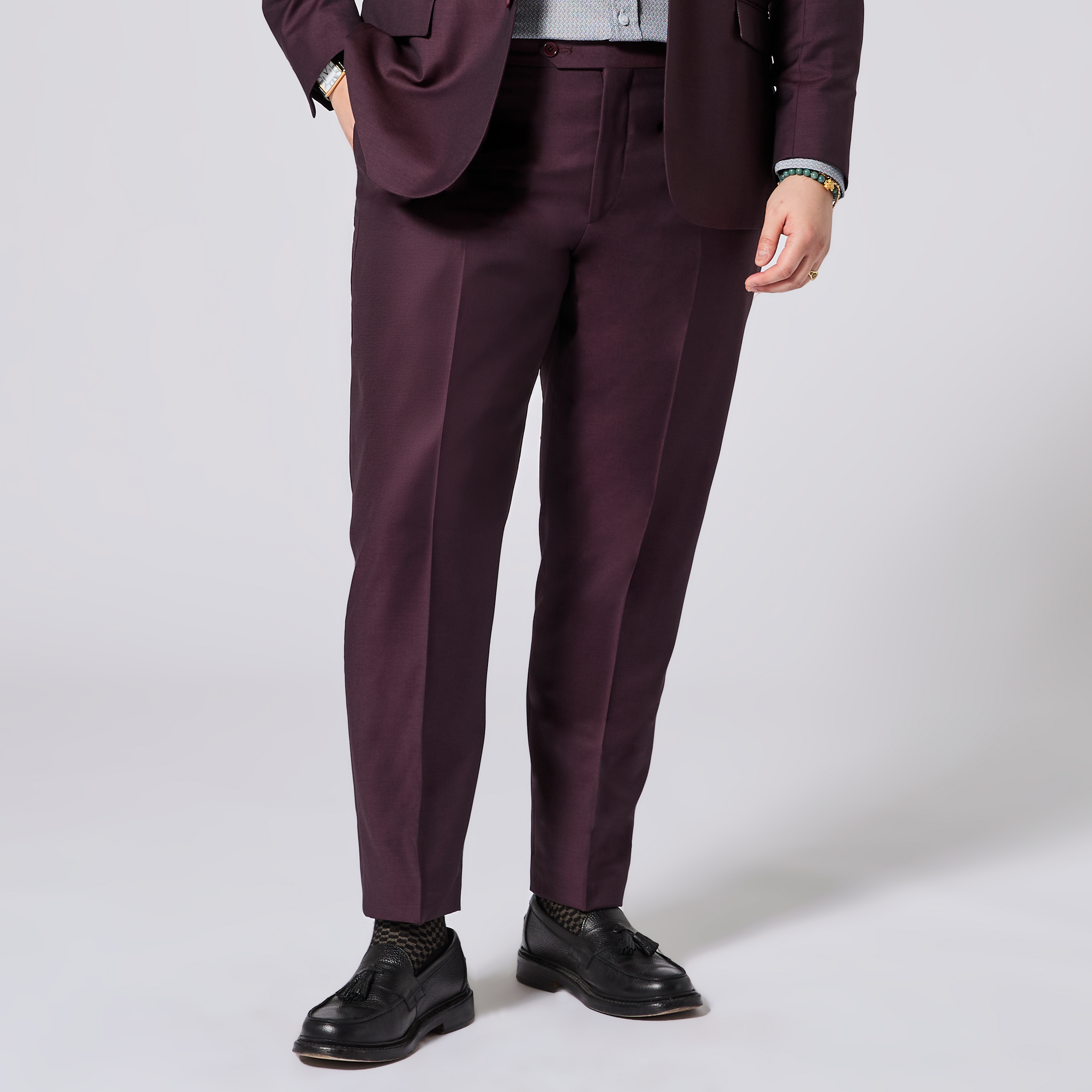 Person wearing a maroon suit with white background. Color: Deep Oxblood