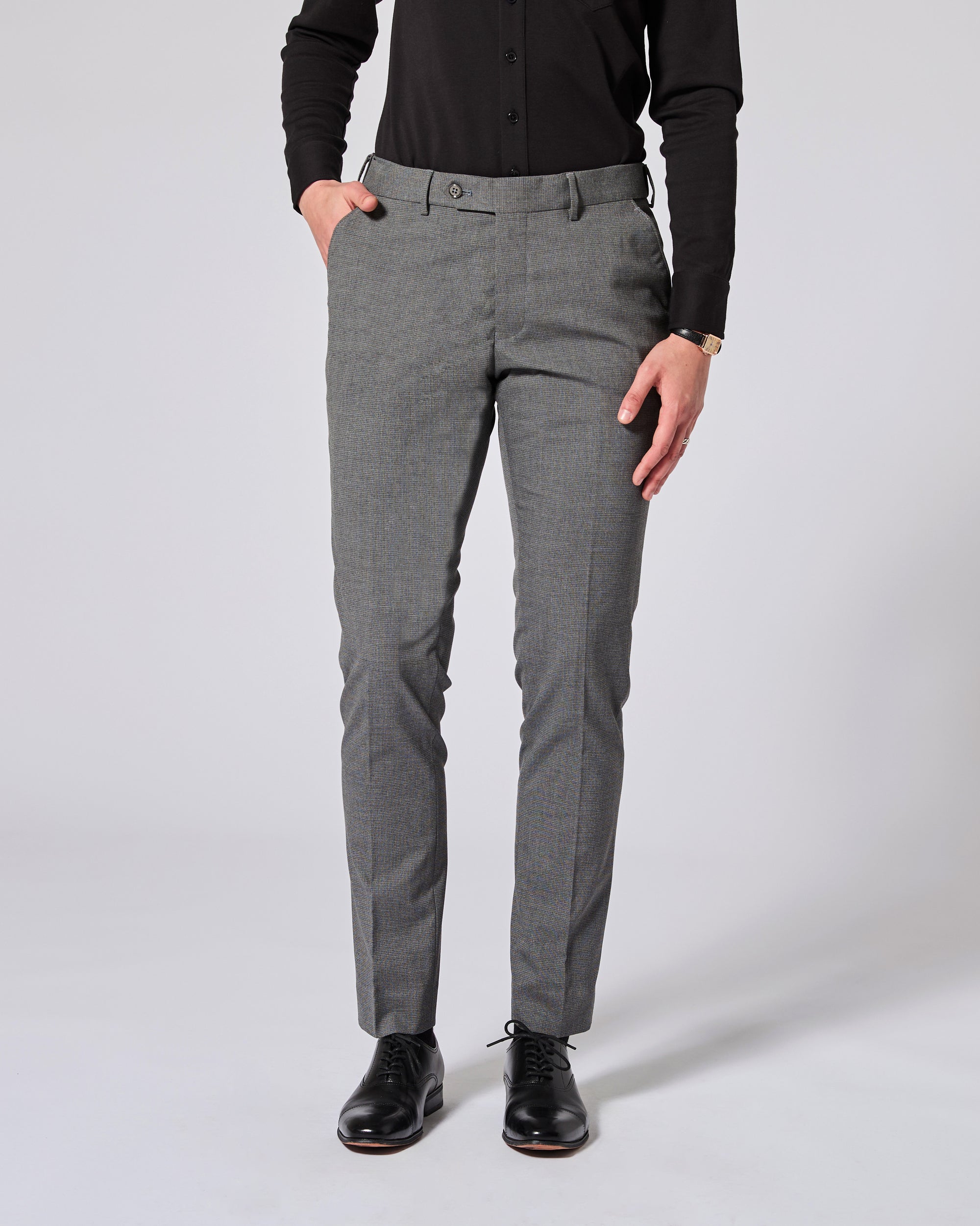 Person wearing gray pants and black shoes on a white background. Color: Gray Lattice