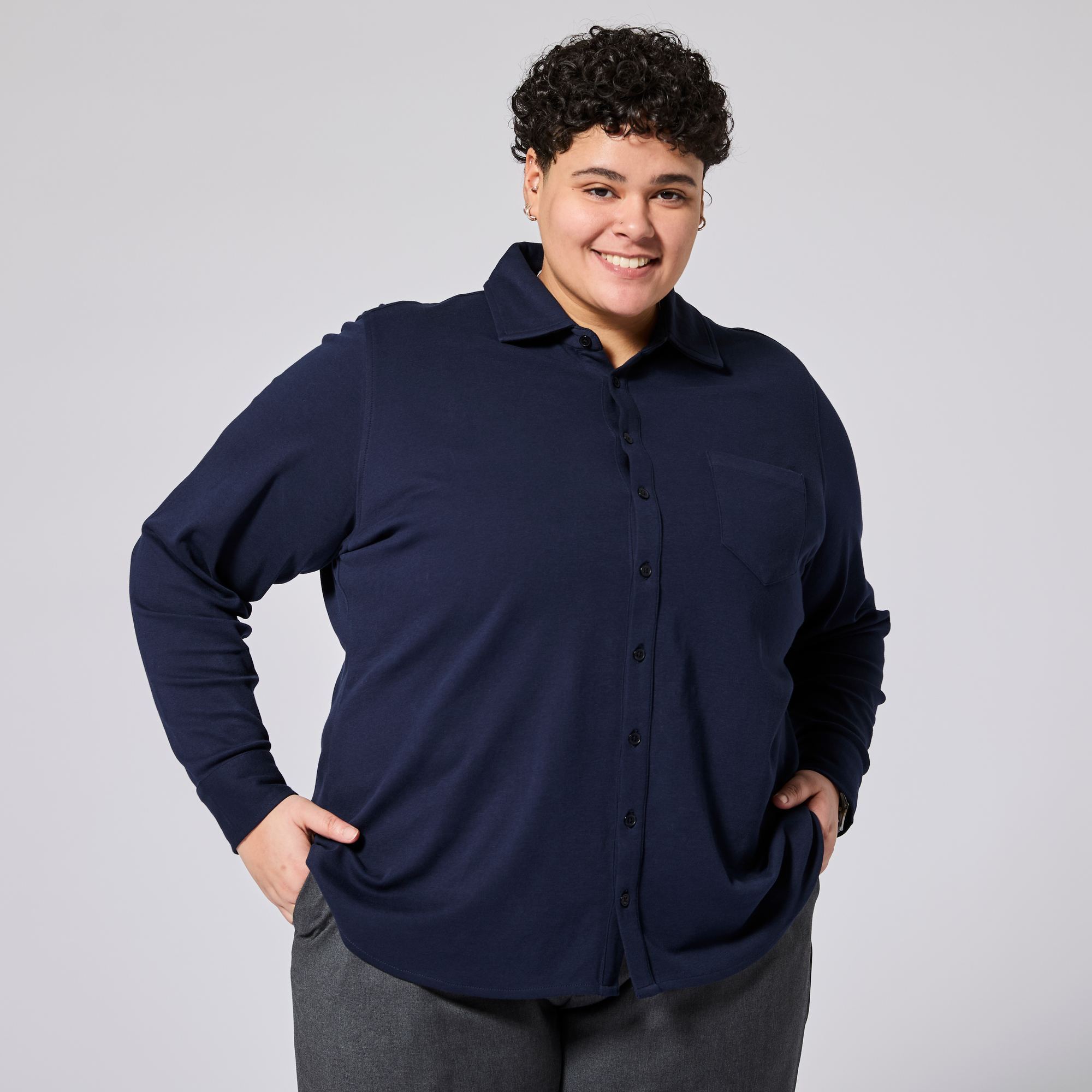 Model wearing a navy blue button-up shirt against a gray background. Color: Navy