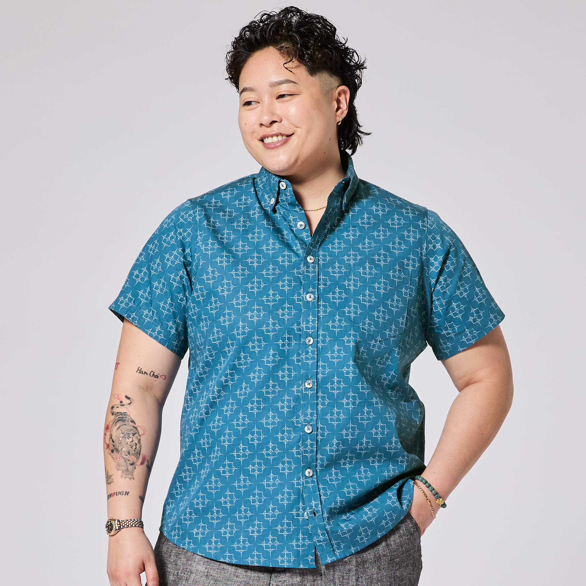 model wearing a blue patterned shirt on a gray background. Color: Signal Blue 