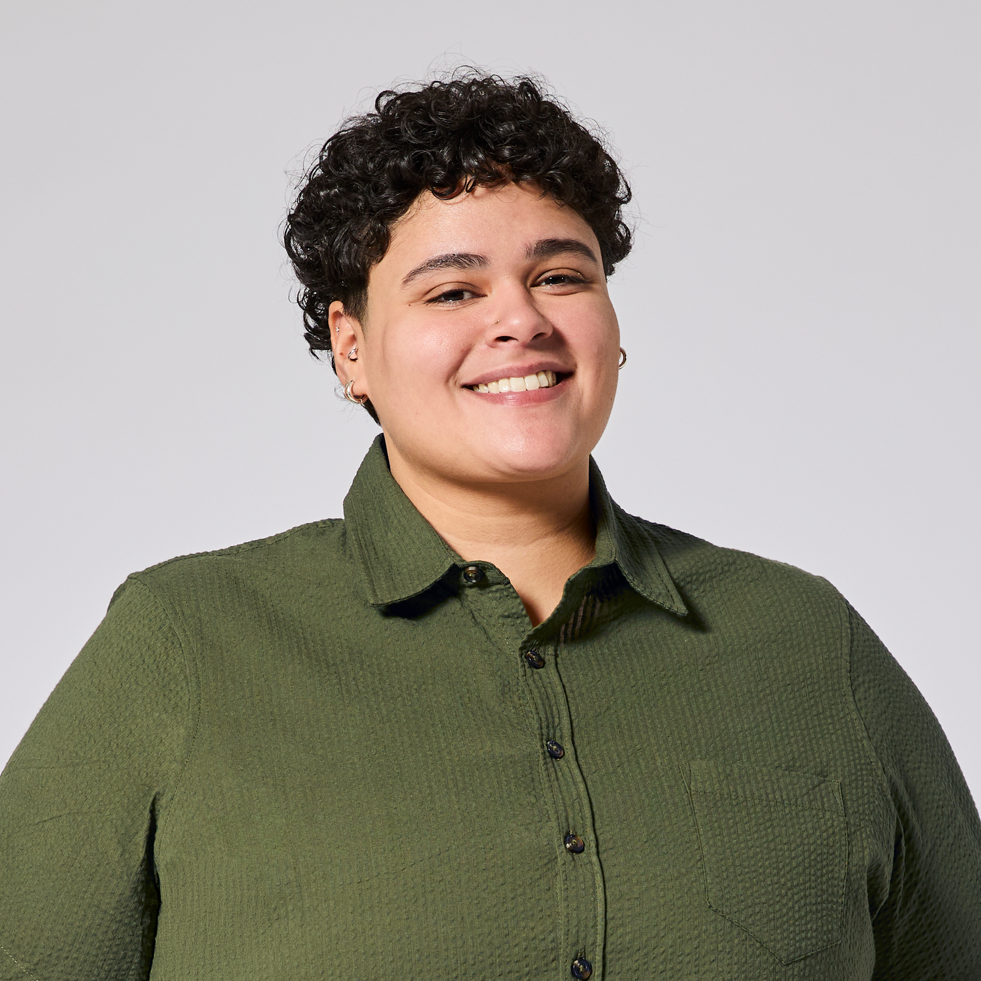 Womens short sleeve green shirt against a plain background.  Made by Kirrin Finch. Color: Nopales