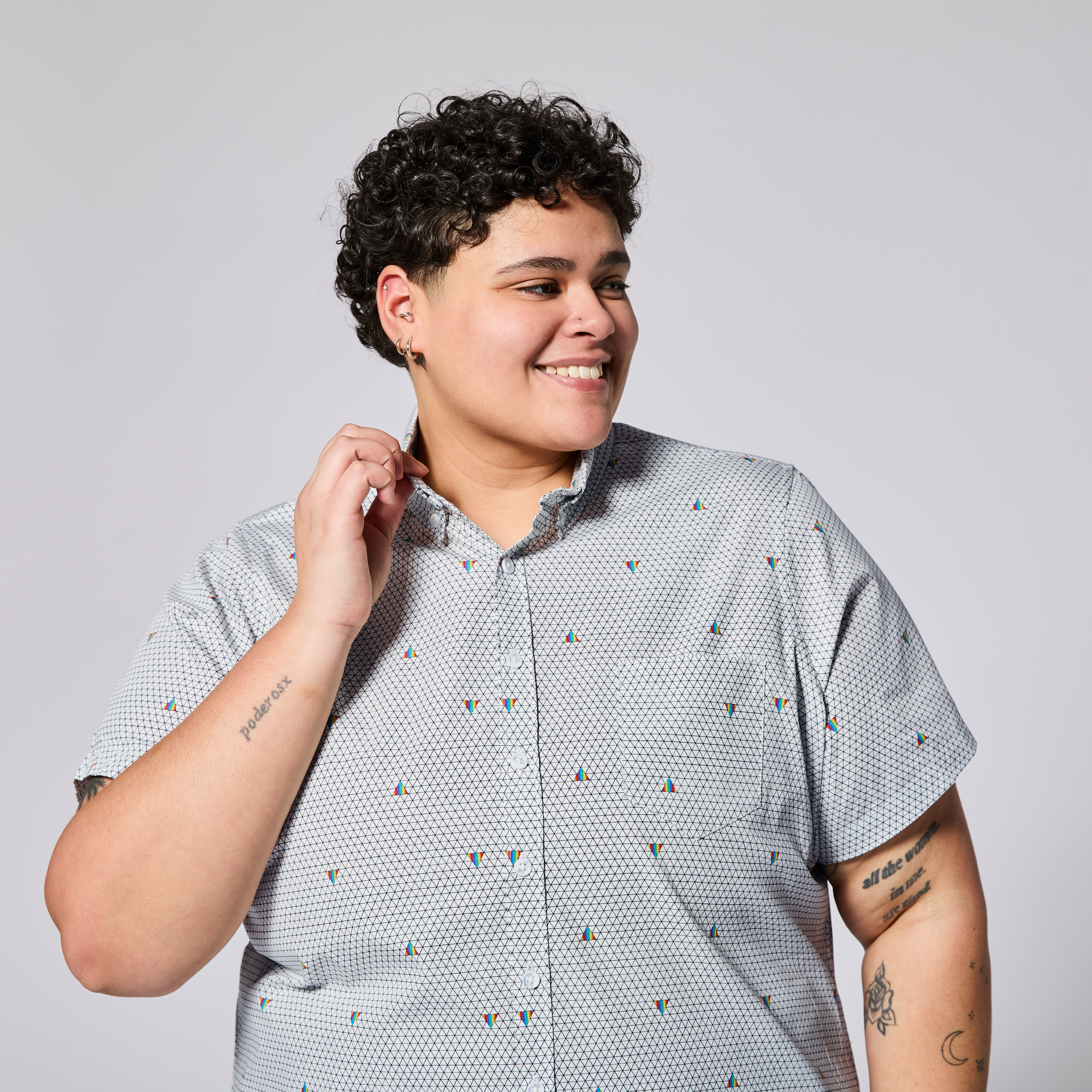 Model wearing the pride prism Ray short sleeve shirt.  Color: Pride Prism