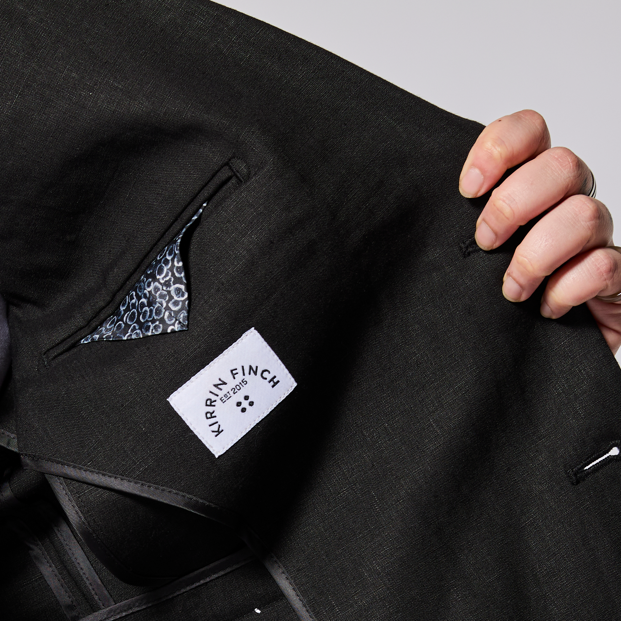 Black suit jacket with a Kirrin Finch label on a light gray background. Color: Black