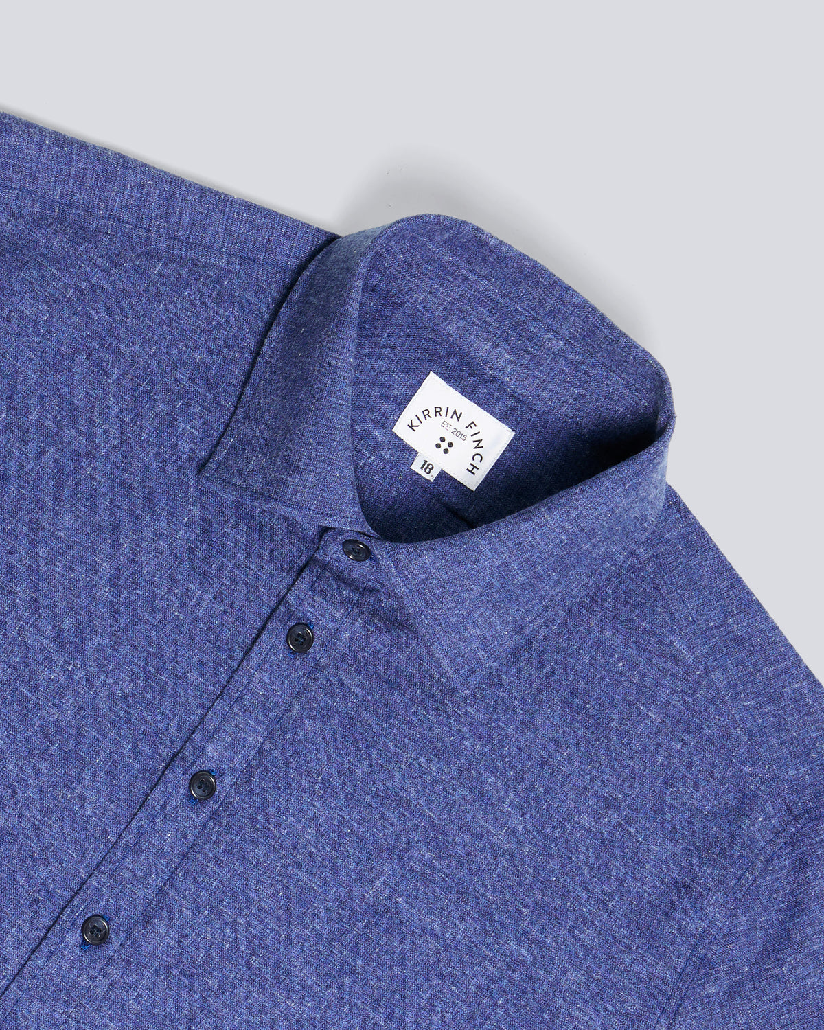 Close-up of a blue heathered long-sleeve shirt collar. Color: Blue Marl