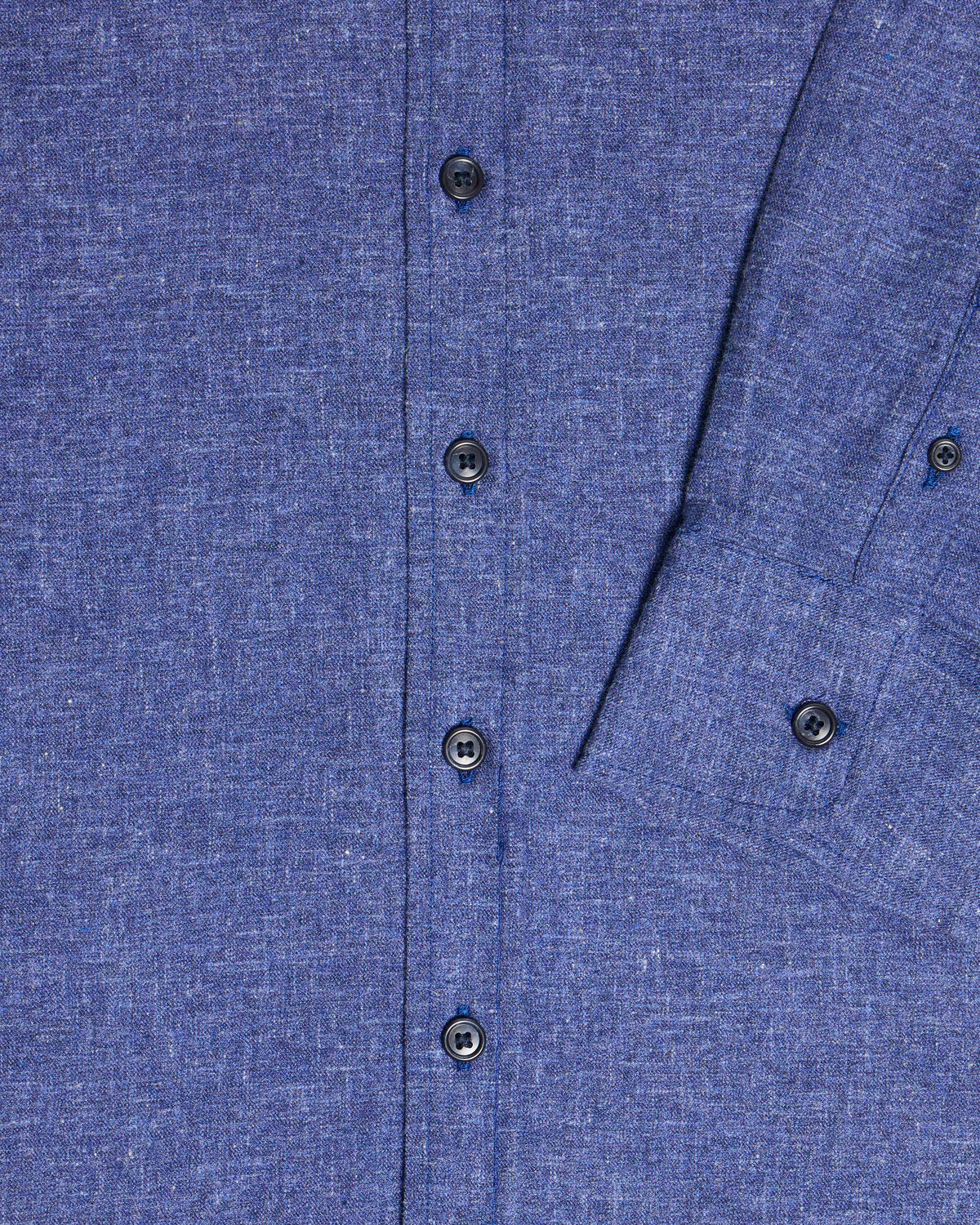 Close-up of a blue textured fabric shirt with dark buttons and a visible seam detail. Color: Blue Marl