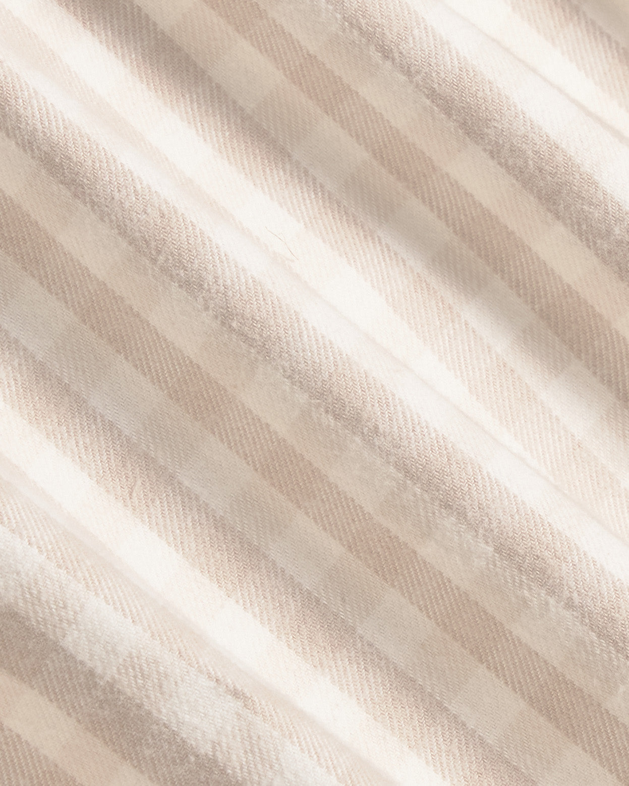 A close-up of a soft, textured fabric with diagonal stripes in warm beige and cream tones. Color: Cream Check