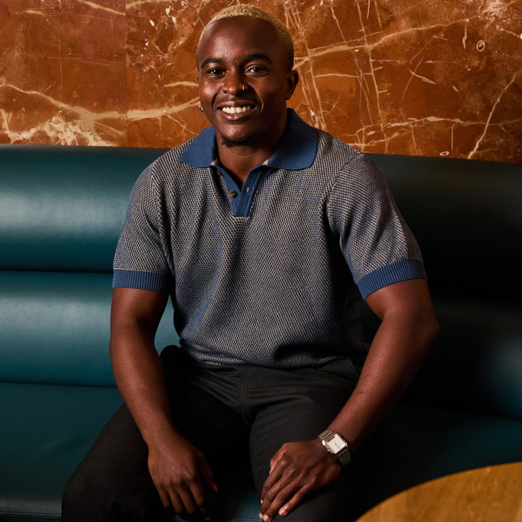 Trans man in the denim and beige pique polo by Kirrin Finch