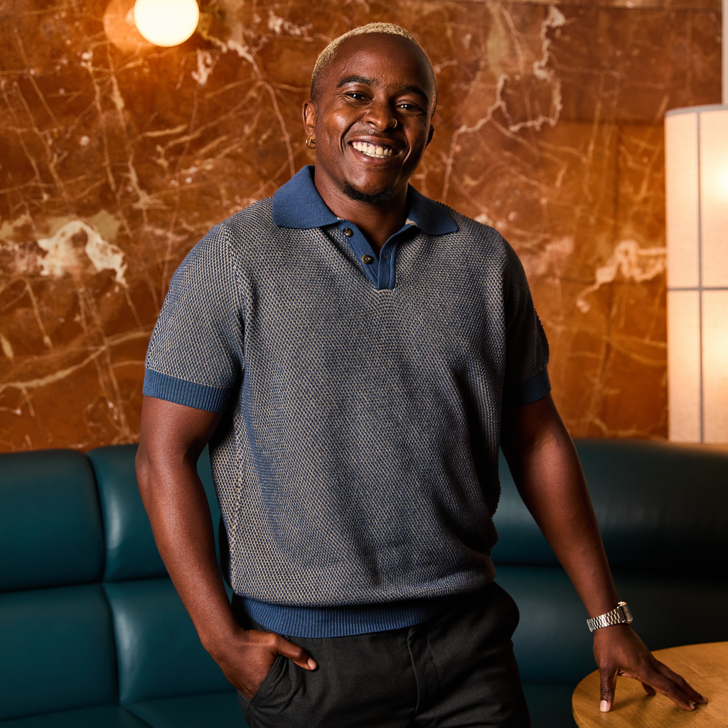 The denim and beige pique polo made for women, trans, and non-binary folks