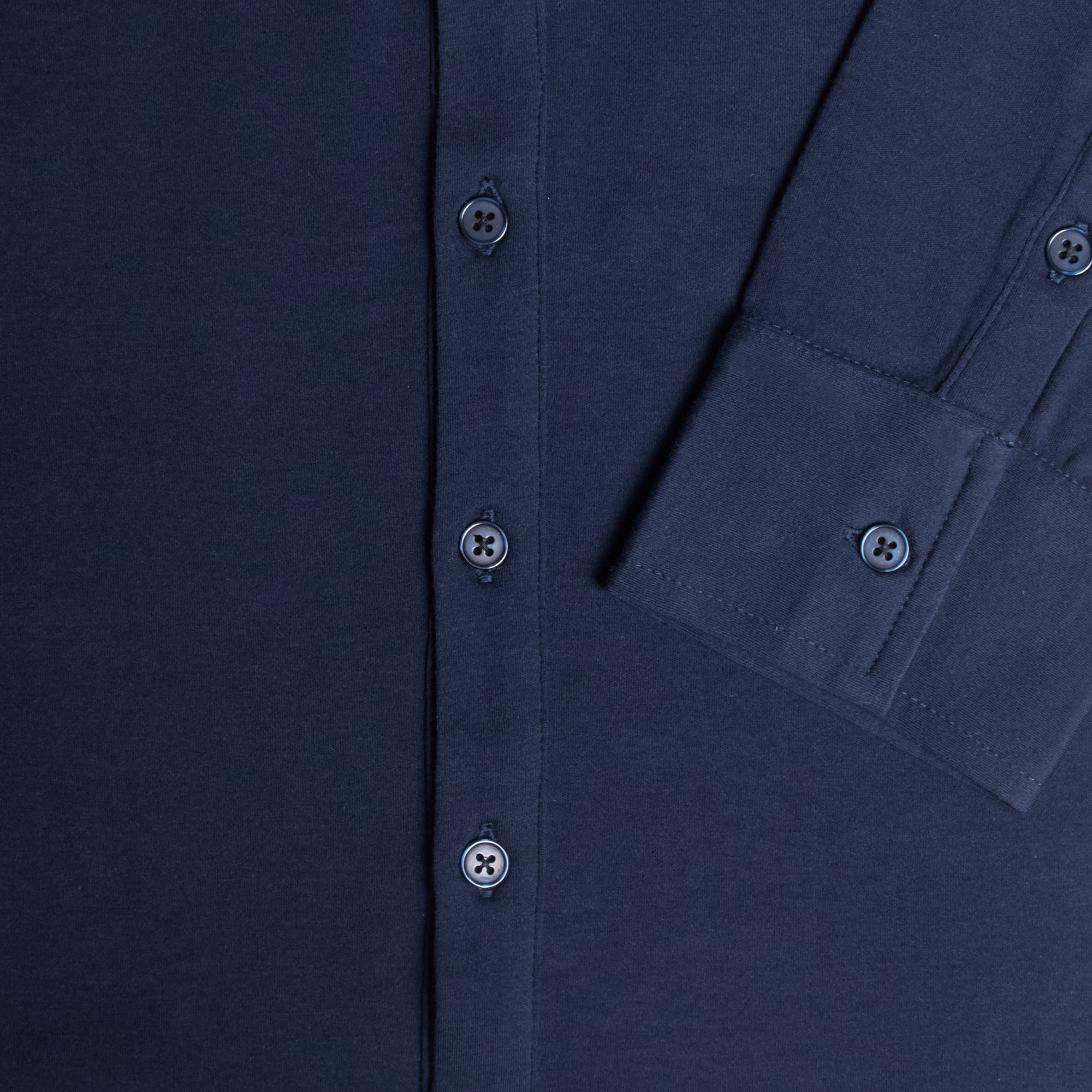 Close-up of a black shirt with button details. Color: Navy
