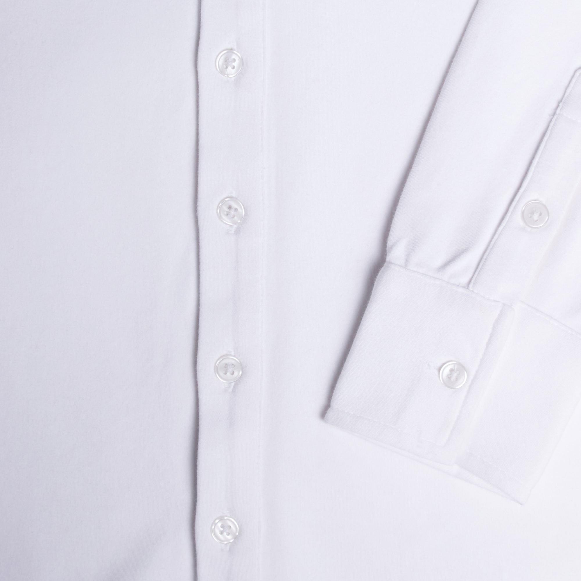 Close-up of a black shirt with button details. Color: White